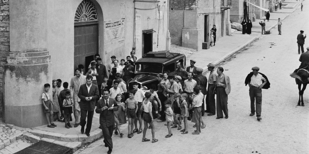 how does the games depiction of the Mafias involvement in local festivities and traditions compare to historical accounts in Mafia The Old Country 1757108465 GameOLL